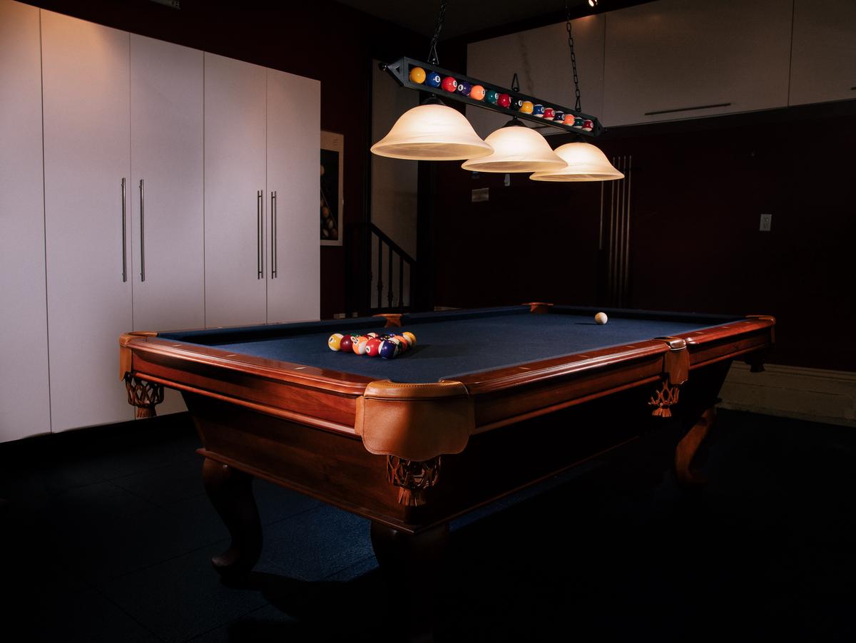 A person preparing to take a shot in Billiards